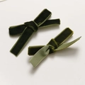 Detail view of dark green velvet bow hair clips with contrasting light green ribbon lining - Dark Green