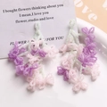 Handmade beaded floral tassel earrings in soft pink and purple tones with green accents - Pink+Purple