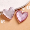 Macro detail of resin heart-shaped DIY jewelry charms with pink foil and glitter - Pink Heart