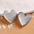 Macro detail of silver heart resin earrings with unique metallic foil crinkle texture - White Heart