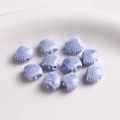 Macro view of 12mm lavender shell-shaped ceramic beads with smooth glazed finish for DIY - 1 Piece / Blue