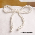 Dettaglio macro di un fiocco di perle da 58mm per gioielli fai-da-te su piatto bianco - Stile Fiocco Intrecciato (10#)