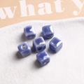 Macro shot of 9mm square gradient purple glazed ceramic beads with pre-drilled holes - 1 Piece / Dark Blue