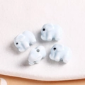 Macro view of four light blue elephant ceramic beads for DIY jewelry making - 1 Piece / Light Blue
