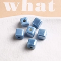 Macro detail of sky blue square ceramic beads with glossy glaze for DIY jewelry making - 1 Piece / Light Blue