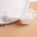 Macro detail of soft white organza ribbon bow showing delicate mesh fabric texture - Pure White