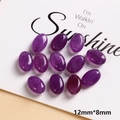 Macro detail of 12mm x 8mm purple oval natural stone beads with smooth polished finish - Purple