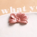 Close-up of a glossy dusty pink resin flower charm for DIY earrings and hair accessories - Pink
