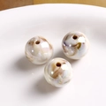 Macro detail of aurora acrylic round beads with marble texture for DIY jewelry making - Marble White