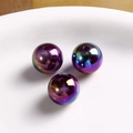 Macro shot of three baroque iridescent round acrylic beads with metallic gradient finish - Iridescent Purple