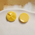 Detail of 20mm bright yellow resin windmill charm with glossy finish on ceramic tray - Yellow