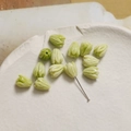 Detail view of light green tulip bud shaped resin beads for DIY jewelry with center hole - Tulip Bud (1#) / 1 Piece / Fruit Green