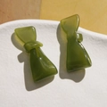 Close-up of elegant green acetate bow hair clip with translucent jade-like texture - Green