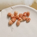Macro detail of tulip bud shell powder beads with vertical engraving and pre-drilled holes - Tulip Flower Bud (18#) / 1 Piece / Brown