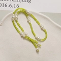 Close-up of long green bead and white pearl chain accessories for DIY shoes and crafts - Grass Green