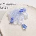 Detailed view of handmade blue beaded bow hair clip with crystal flower and teardrop charm - Blue