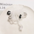 Macro shot of handmade beaded flower jewelry with frosted beads and water drop pendant - White