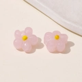 Close-up of pink glass flower charms with yellow center for DIY jewelry making - Pink