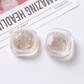 Detail of square resin charms with gold foil flakes and pearl borders for DIY jewelry - White