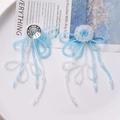 Detailed macro view of handmade blue and white beaded floral earrings with long tassels - Sky Blue