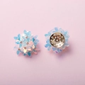 Detailed view of handmade iridescent blue five-petal flower earrings with rhinestone centers - AB White