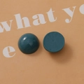 Macro view of dark cyan 18mm resin dome cabochons showing glossy surface and flat matte base - Grey Blue