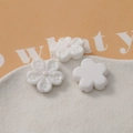 Macro detail of white cherry blossom resin petals with pink center for DIY crafts - White