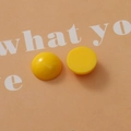 Macro shot of 18mm yellow resin semi-round beads for DIY jewelry and hair accessories - Yellow