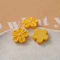 Macro shot of three yellow resin cherry blossom petals with pink stamens for DIY crafts - Yellow