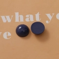 Macro shot of navy blue resin cabochons showing smooth front and matte back for DIY crafts - Dark Blue
