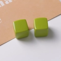 Close-up of 20mm grass green resin cube charms with glossy finish and rounded corners - Fruit Green
