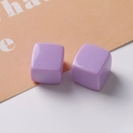 Macro detail of glossy purple 20mm cube resin beads for DIY earring jewelry making - Purple