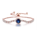 Detail of rose gold adjustable bracelet featuring blue gemstone and cubic zirconia accents - Rose Gold Sapphire Blue Stone
