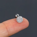 Silver round pave-set zircon helix stud earring with screw back on a fingertip - Silver