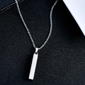 Macro view of vertical bar pendant on minimalist stainless steel necklace chain - 4x30mm / Silver
