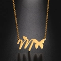 Detailed view of golden stainless steel M letter pendant with heart and butterfly charms - Gold Letter M