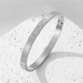 Titanium steel Jesus bangle featuring cross motifs and a textured checkered pattern - Steel