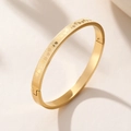 Titanium steel bangle with heart grid pattern and clasp in gold finish - Gold
