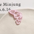 Macro shot of pink acetate butterfly accessory with marble texture and cutout detail - Left Wing / Deep Pink
