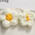 Detailed close-up of handmade crochet flowers in white and yellow yarn with soft texture - Yellow