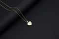 Golden heart necklace featuring a white shell inlay and a gold letter U pendant detail - Shell Heart Letter U (With Chain)