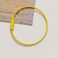 Macro shot of bright yellow steel wire keychain loop with non-slip screw clasp closure - Bright Yellow