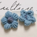 Macro detail of handmade crochet puffy flower charms with purple knit texture for DIY jewelry - Gray Blue
