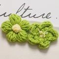 Macro detail of handmade crochet puffy flowers in green and yellow yarn for DIY crafts - Green with Yellow Core