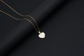 Gold heart necklace with white shell inlay featuring the letter K on a black background - Shell Heart Letter K (With Chain)