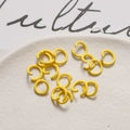 Close-up of yellow matte painted metal open jump rings for DIY jewelry making accessories - Bright Yellow