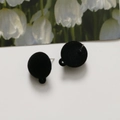 Detailed view of black flocked spherical earring charms with silver pins and hanging loops - Black