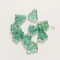 Macro detail of green glass Christmas tree beads with textured dots and central hole - 1 Piece / Lake Green
