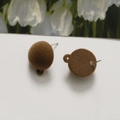 Detail of brown flocked ball stud earrings with metal pins and textured plush surface - Brown