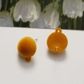 Detail of ginger yellow flocked semi-round earring studs with metal hanging loop - Orange